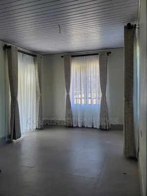 Dress Tall Windows With Elegant Flowing Curtains Fabrics.