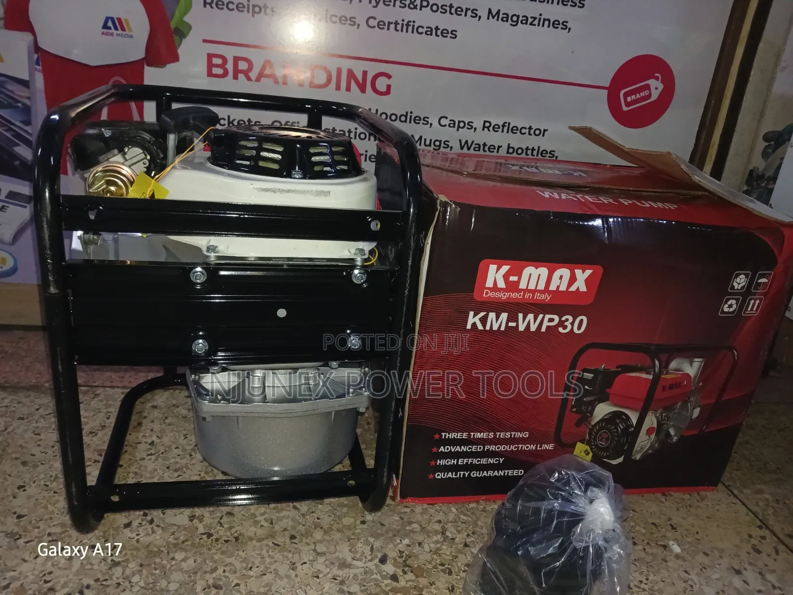 K-Max KM-WP30 Petrol-Powered Water Pump Sitting on Its Branded Box.