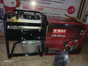 K-Max KM-WP30 Petrol-Powered Water Pump Sitting on Its Branded Box.