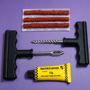 Tire Repair Kit With Brown Rubber Strips and Solution