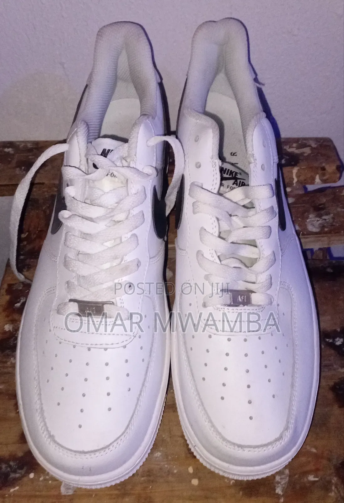 White Nike Air Force 1 '07 Low-Top Sneakers With a Black Swoosh.