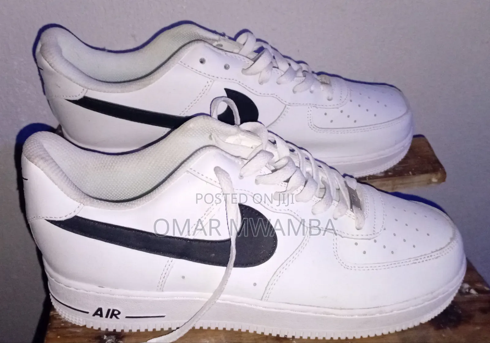 White Nike Air Force 1 '07 Low-Top Sneakers With a Black Swoosh.