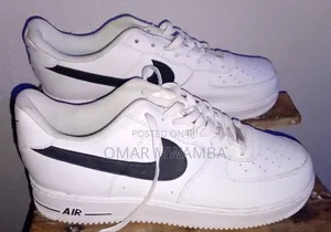 White Nike Air Force 1 '07 Low-Top Sneakers With a Black Swoosh.