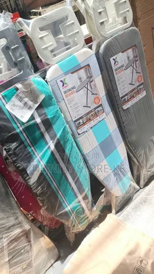 Metallic Foldable Ironing Boards With Patterned Fabric Covers.