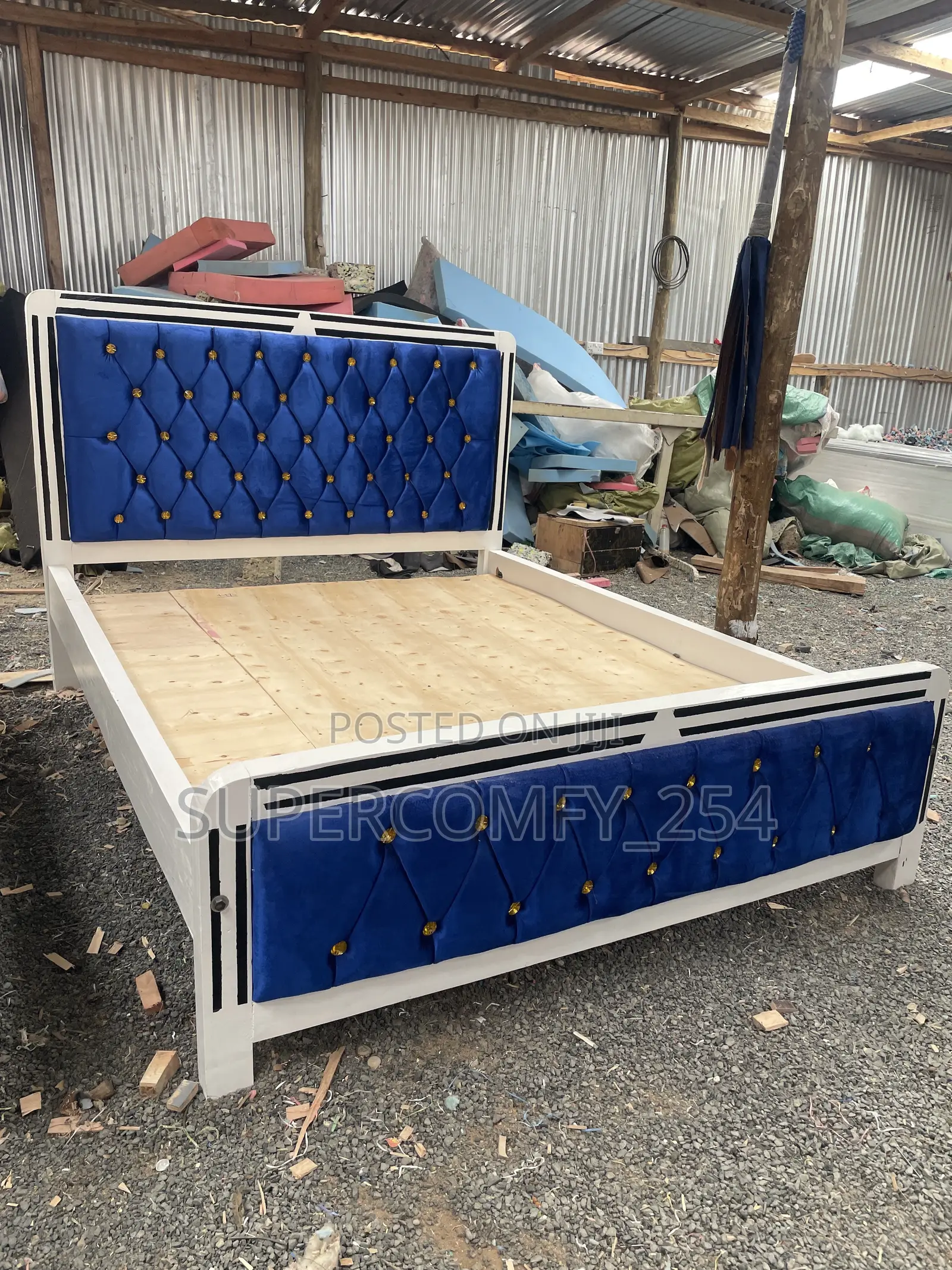 A Colourful Blue Fabric, White & Black Wooden Framed Mocket Bed