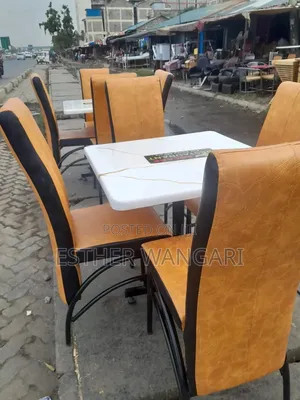 A Set of Four Brown Seats and a Table