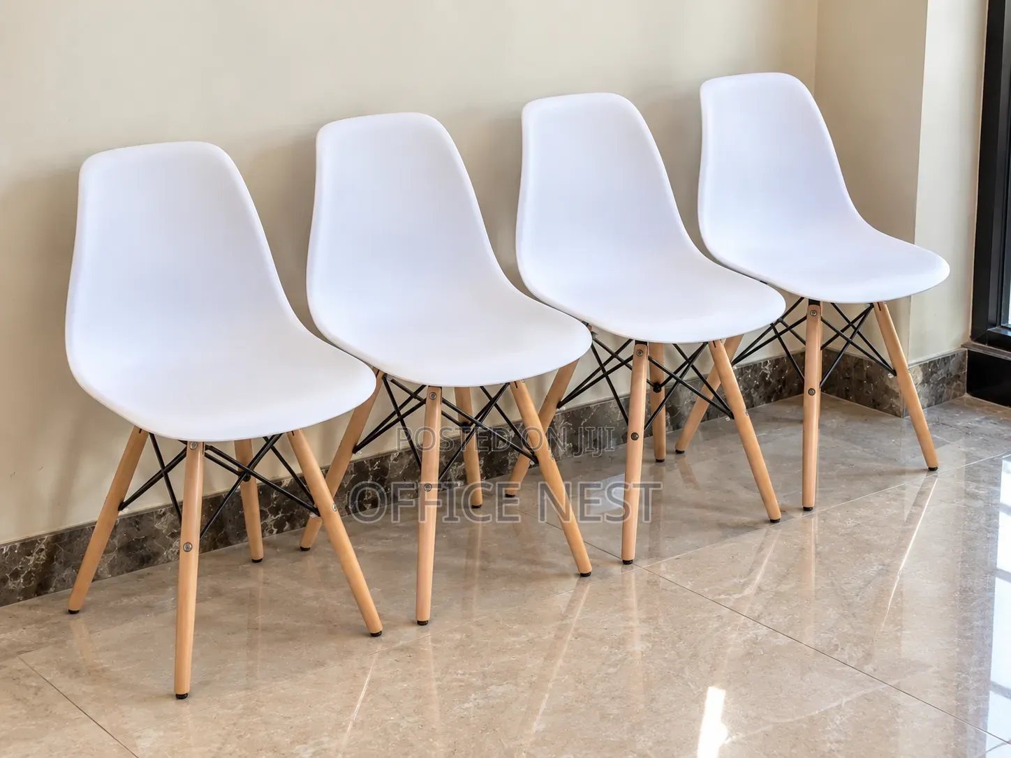 White Eames Plastic Chairs With Wooden Legs.