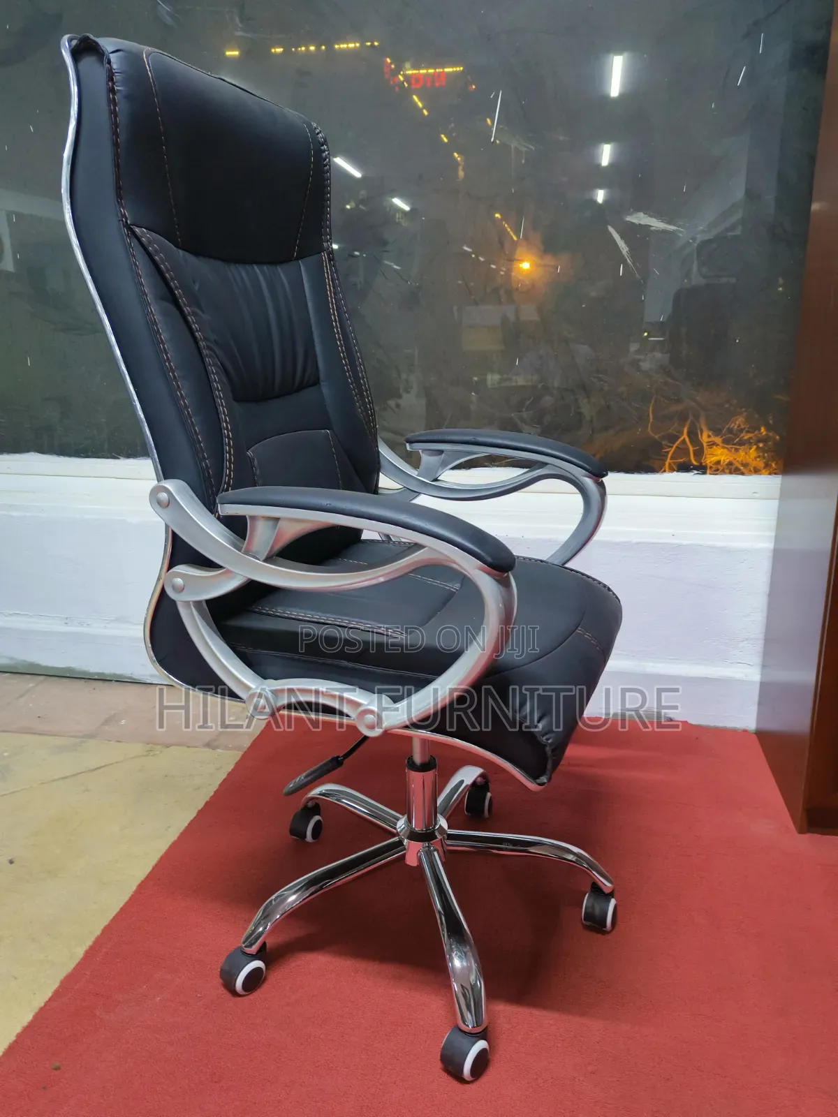Executive High-Back Leather Office Chair With Chrome Armrests.