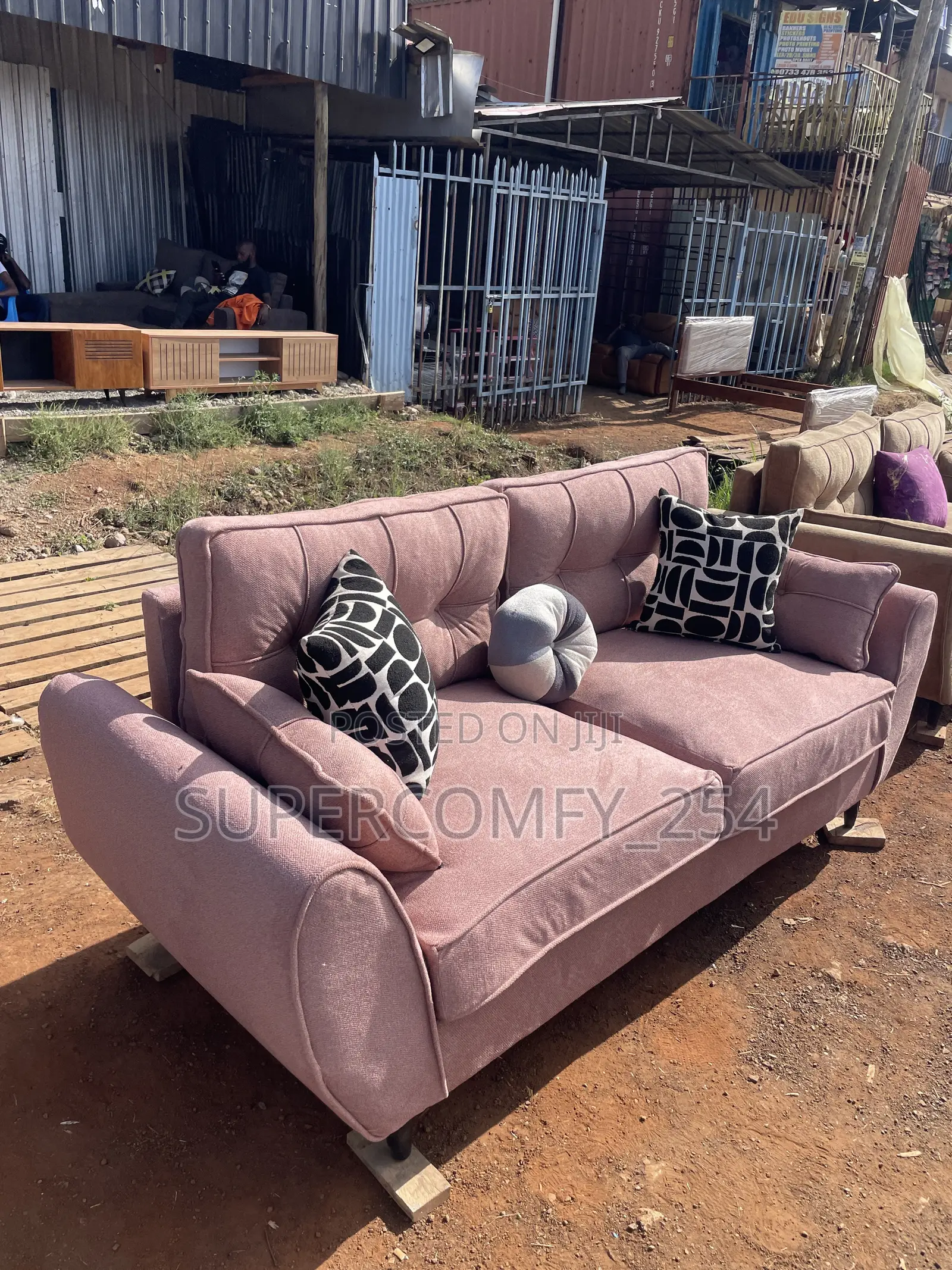 A Pink Fabric Three Seater Butterfly Couch