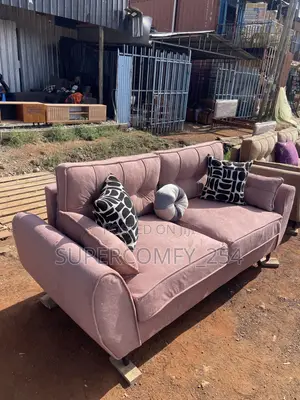 A Pink Fabric Three Seater Butterfly Couch