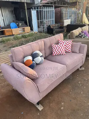 A Pink Fabric Three Seater Butterfly Couch