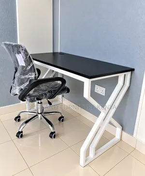 Black Office Desk With White Geometric Metal Frame and Office Chair