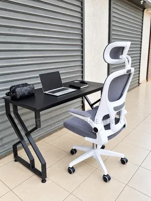 Modern Black Office Desk With White Ergonomic Mesh Chair