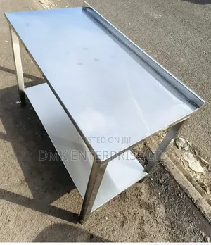 Stainless Steel Work Table With an Undershelf and a Backsplash.