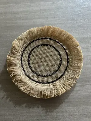 Brown Coaster With Black Inner Circles.