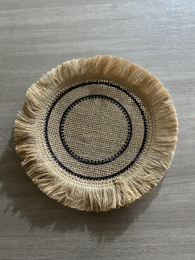 Brown Coaster With Black Inner Circles.