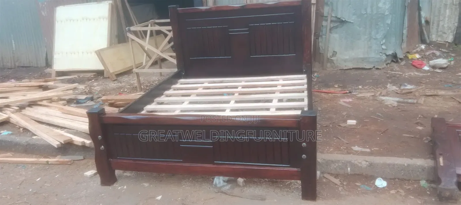 Dark Brown Hardwood Panel Bed Frame With a Plain Plywood Mattress Base
