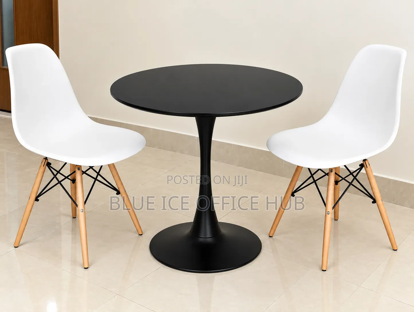 Black Round Table With White Eames Chairs