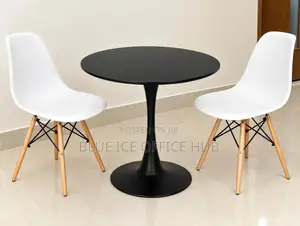 Black Round Table With White Eames Chairs