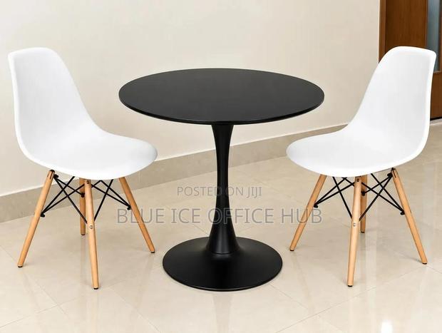 Black Round Table With White Eames Chairs - thumbnail 2