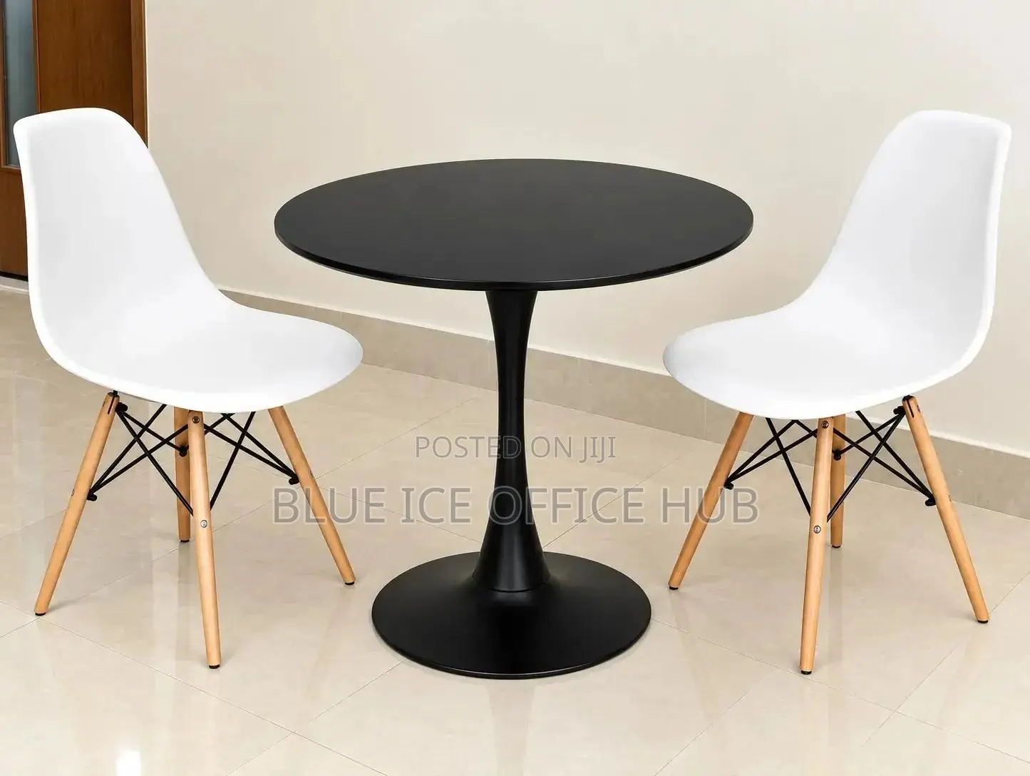 Black Round Table With White Eames Chairs