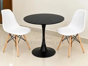 Black Round Table With White Eames Chairs