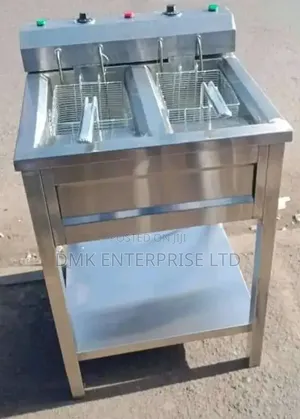 Electric Double Deep Fryer With a Stainless Steel Body and Stand.