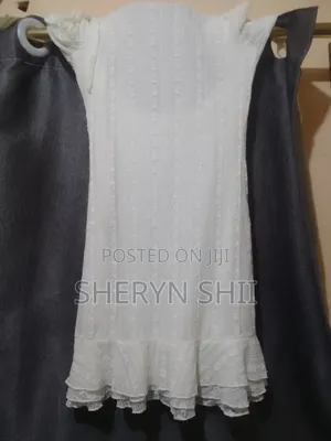 Beautiful White Sleeveless Dress With Layered Ruffle Hem