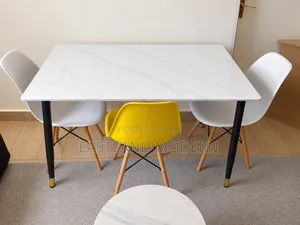 White Marble Dining Table With Eames Chairs