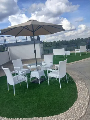 White Outdoor Rattan Furniture Set With Glass Table and an Umbrella