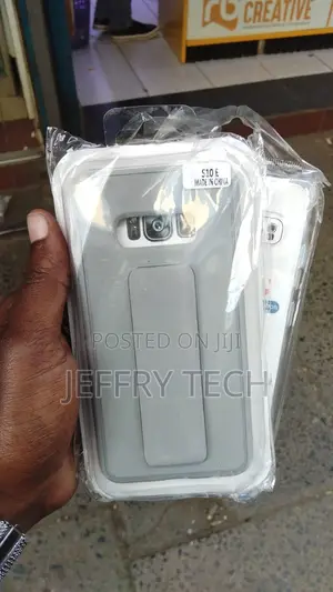 Grey and White Phone Case Inside Plastic With a Sticker That S10E