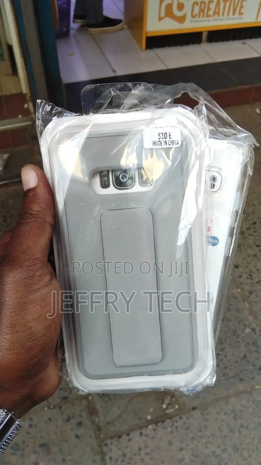 Grey and White Phone Case Inside Plastic With a Sticker That S10E