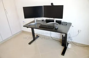 Electric Standing Desk With Black Top and T-Shaped Legs