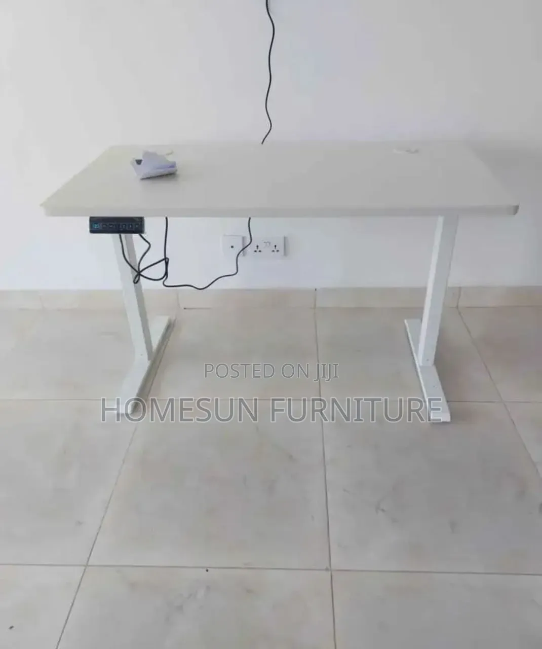 Electric Standing Desk With Black Top and T-Shaped Legs