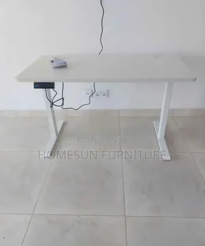 Electric Standing Desk With Black Top and T-Shaped Legs
