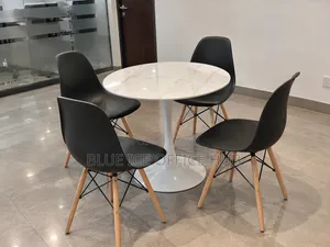 Round Dining Table With 4 Black Eames Chairs